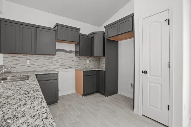 a view of a kitchen with a sink and cabinets