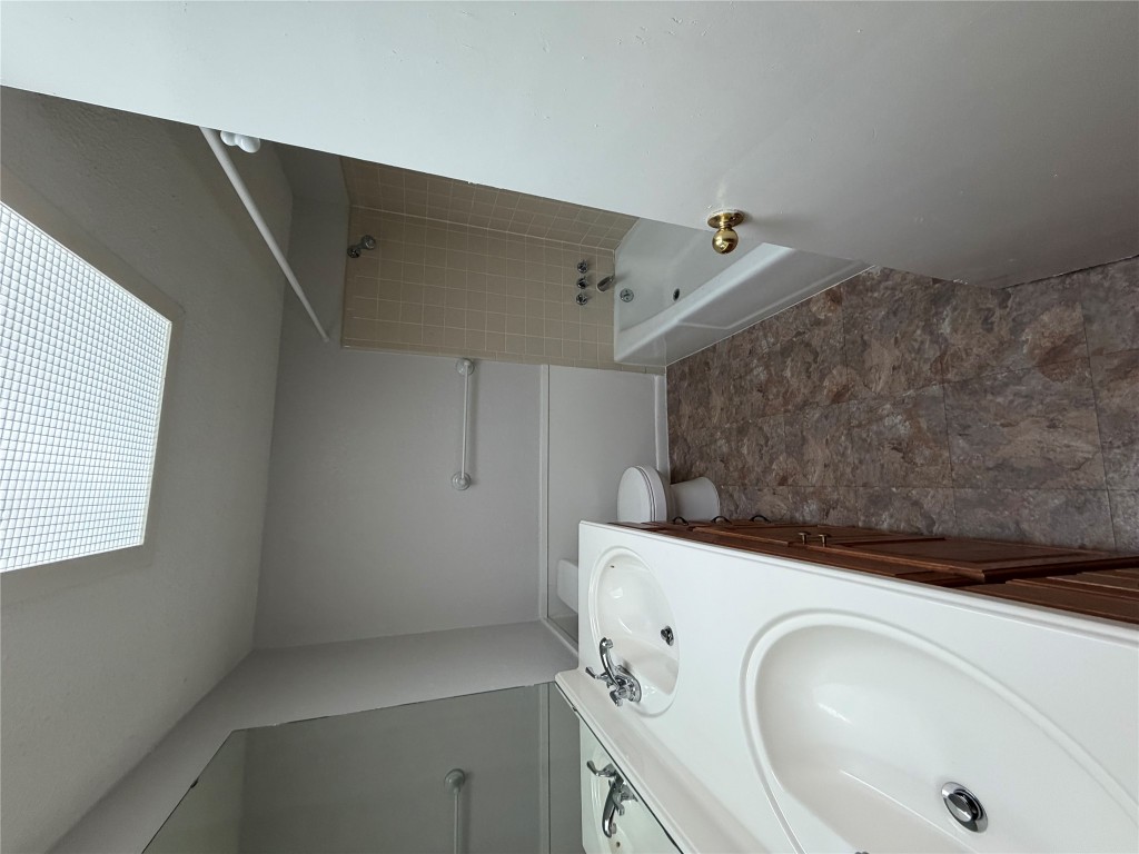 1725 Toomey Road Austin, TX 78704 - Photo 10 of 11 Bathroom with double vanity and shower combination