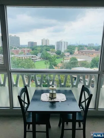 a view of a city from a balcony with furniture