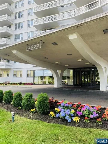 a front view of a building with an garden