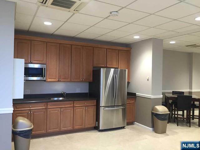 2000 Linwood Avenue, Unit 10M Fort Lee, NJ 07024 - Photo 24 of 28 a kitchen with stainless steel appliances granite countertop a refrigerator sink and stove