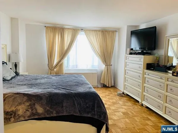 a bedroom with a bed and flat screen tv