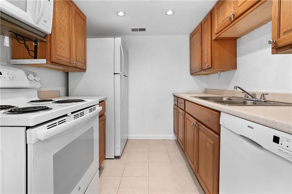 321 Ridge Point Circle, Unit B12 Bridgeville, PA 15017 - Photo 8 of 26 a kitchen with stainless steel appliances granite countertop a stove and a refrigerator