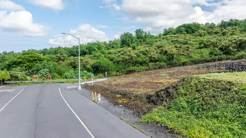 a view of a street with a yard
