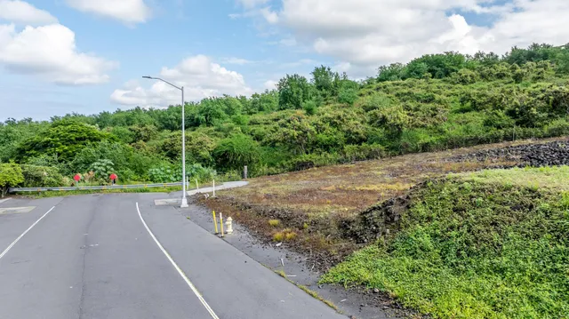 a view of a street with a yard