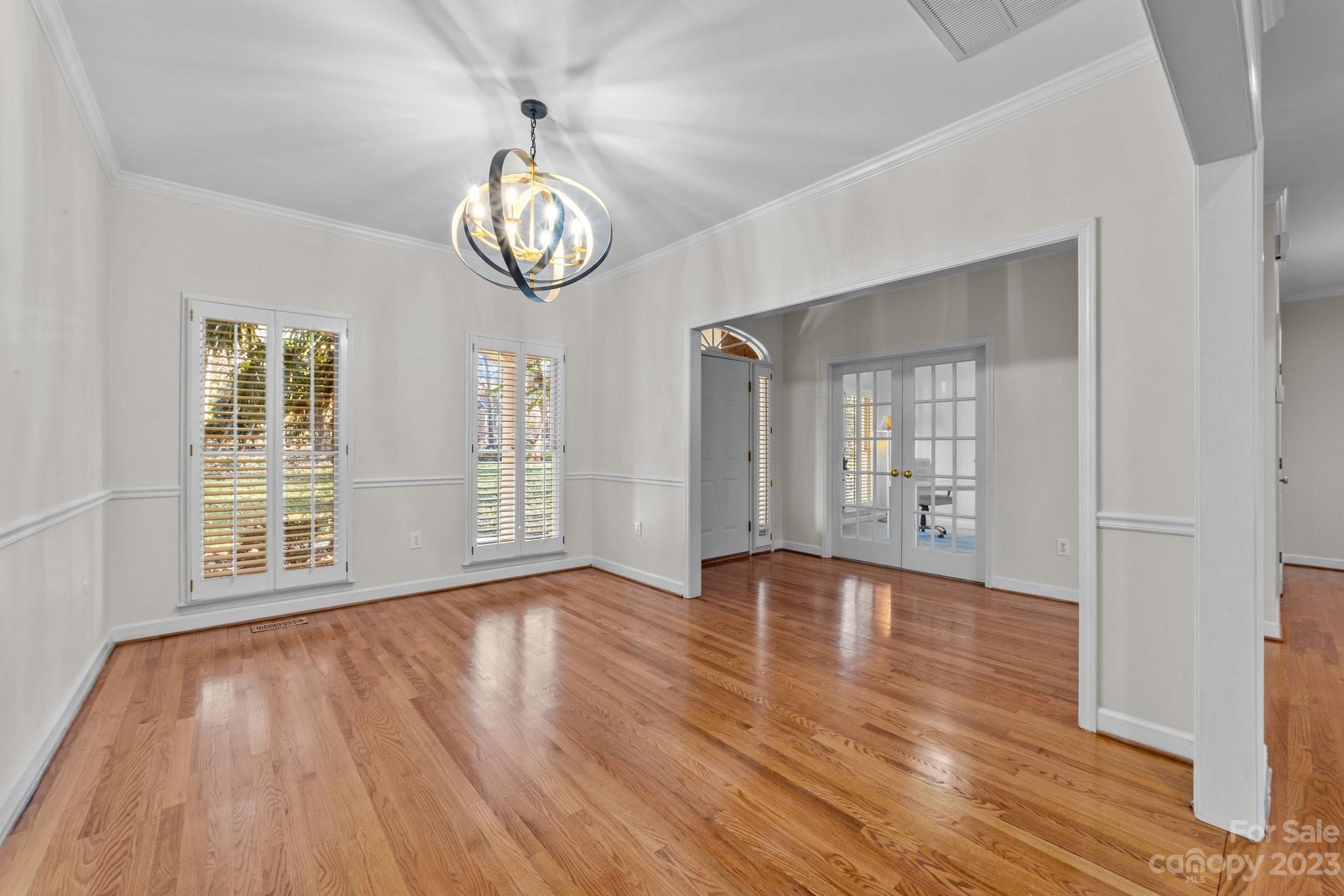 5476 Deer Run Court Davidson, NC 28036 - Photo 12 of 48 a view of an empty room with wooden floor and a window