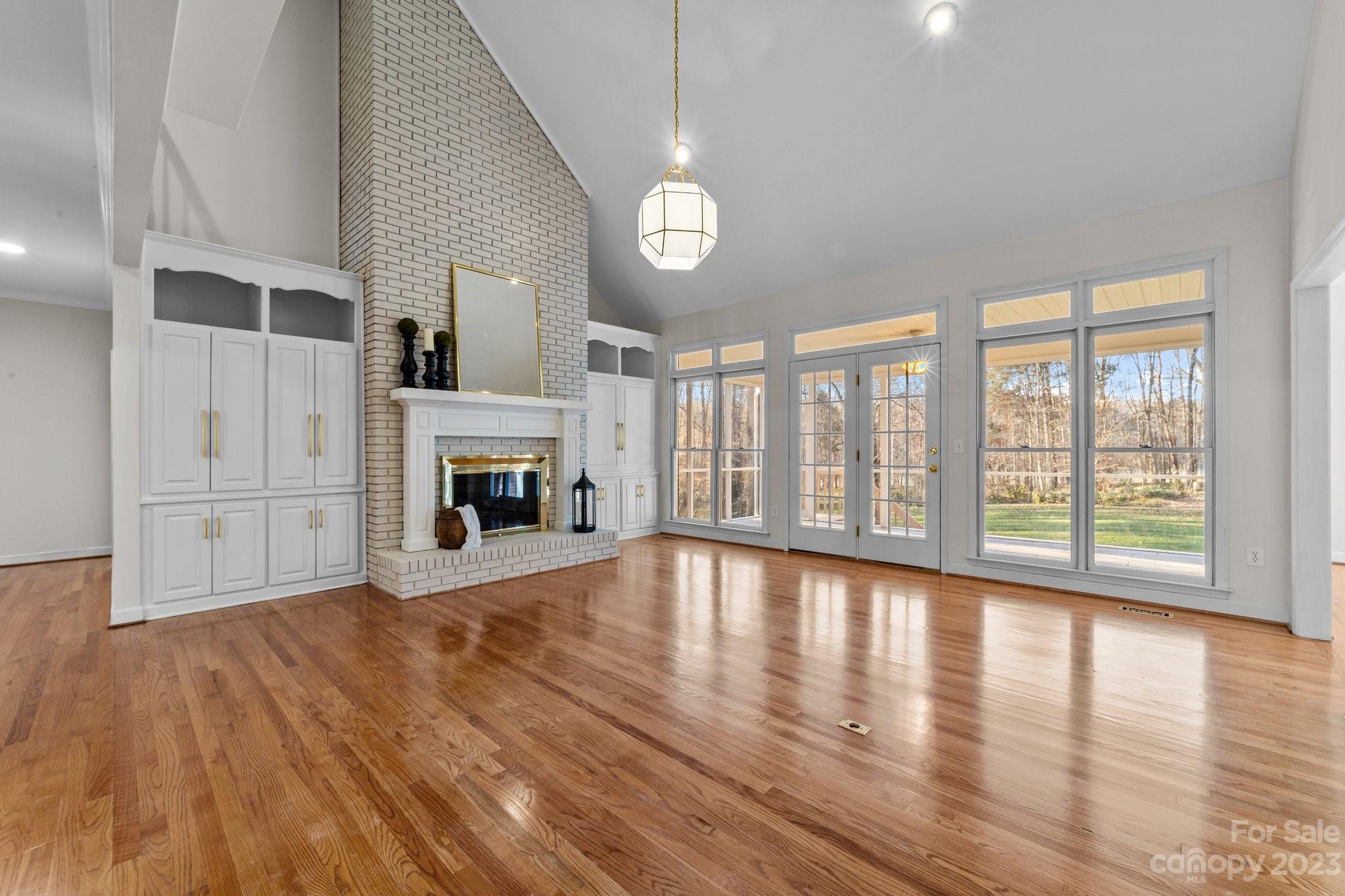 5476 Deer Run Court Davidson, NC 28036 - Photo 13 of 48 a view of an empty room with wooden floor and a window