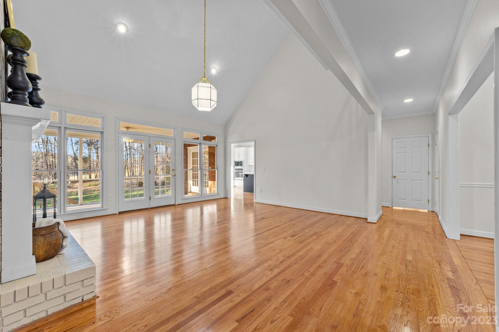5476 Deer Run Court Davidson, NC 28036 - Photo 17 of 48 a view of an empty room with wooden floor and a window