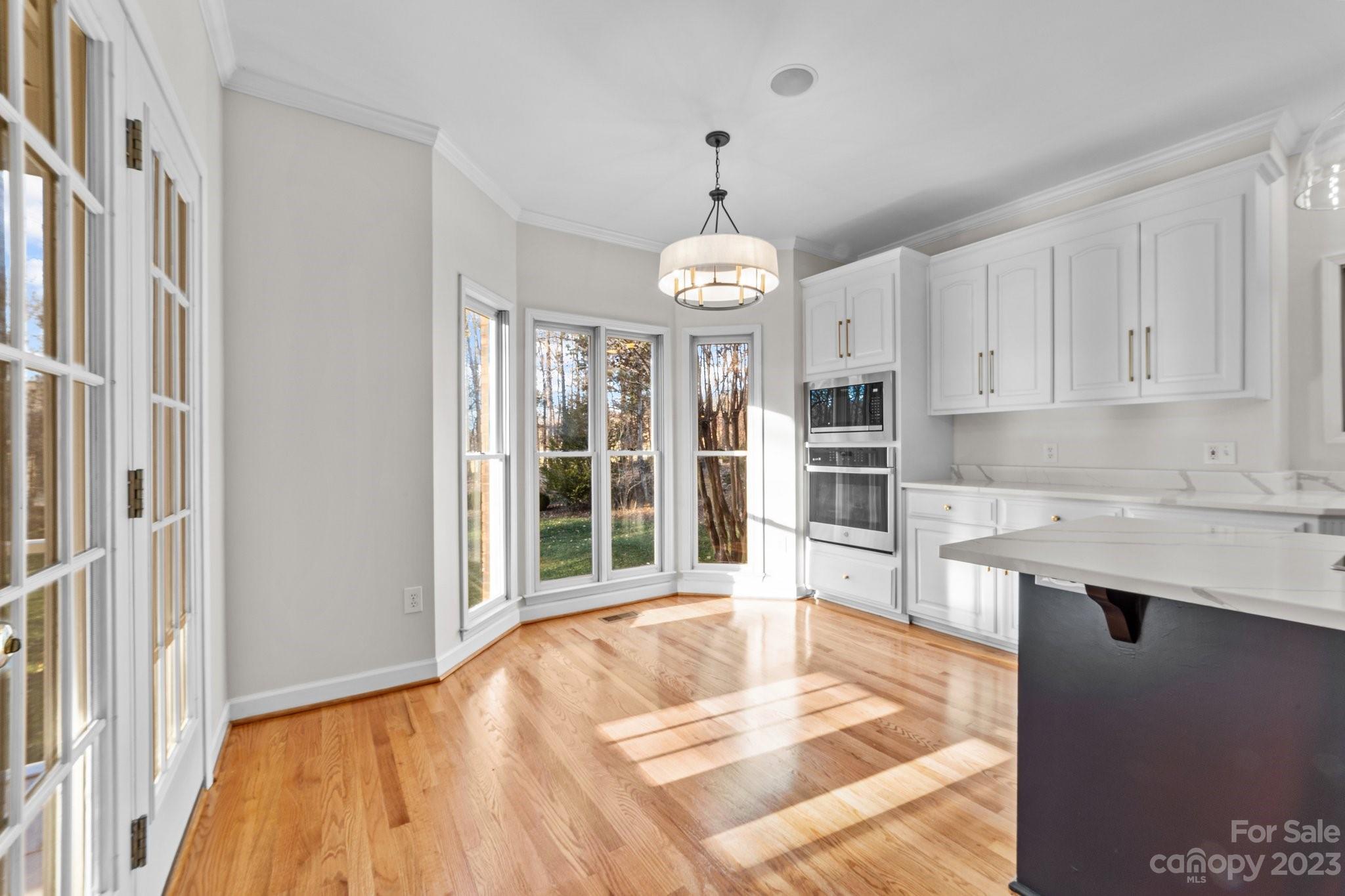 5476 Deer Run Court Davidson, NC 28036 - Photo 20 of 48 a open kitchen with granite countertop a stove and a sink with granite countertops