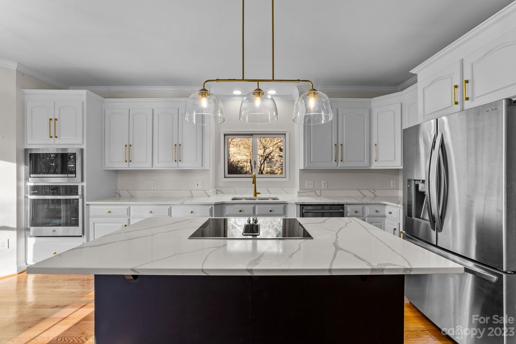 5476 Deer Run Court Davidson, NC 28036 - Photo 2 of 48 a kitchen with stainless steel appliances a sink a microwave a refrigerator and cabinets