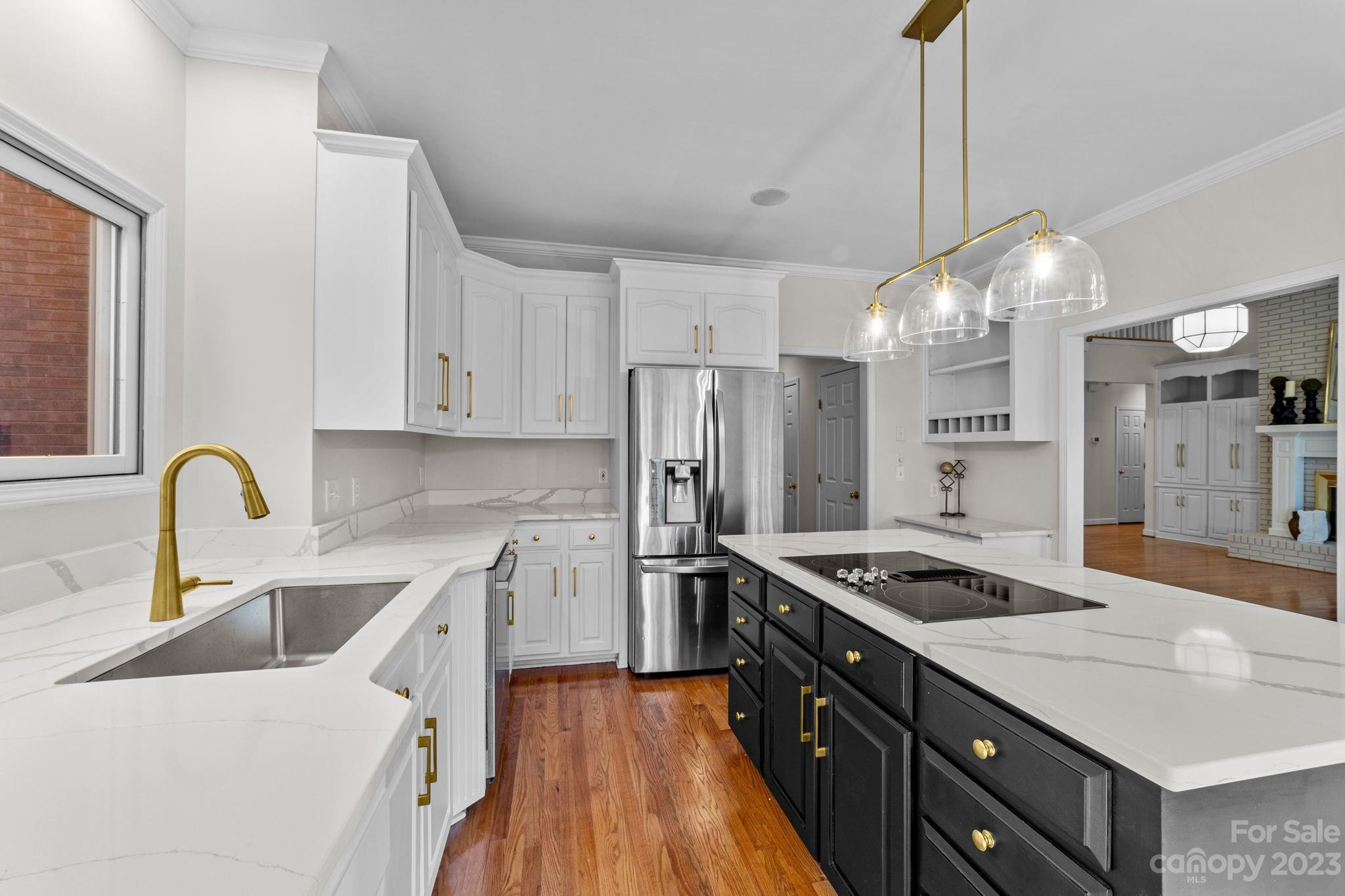 5476 Deer Run Court Davidson, NC 28036 - Photo 23 of 48 a kitchen that has a sink stainless steel appliances a counter space and cabinets