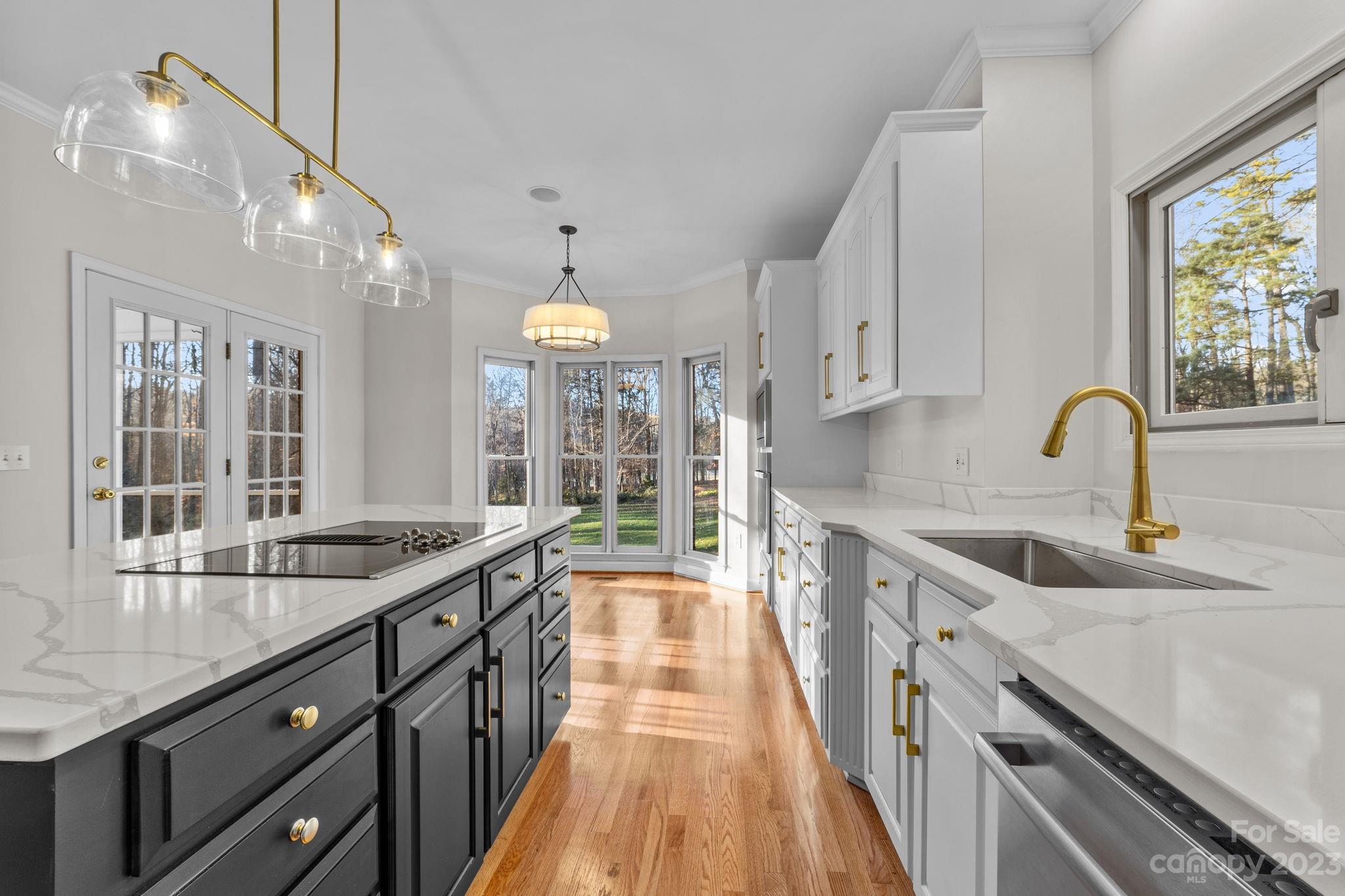 5476 Deer Run Court Davidson, NC 28036 - Photo 24 of 48 a kitchen with granite countertop a sink and a stove