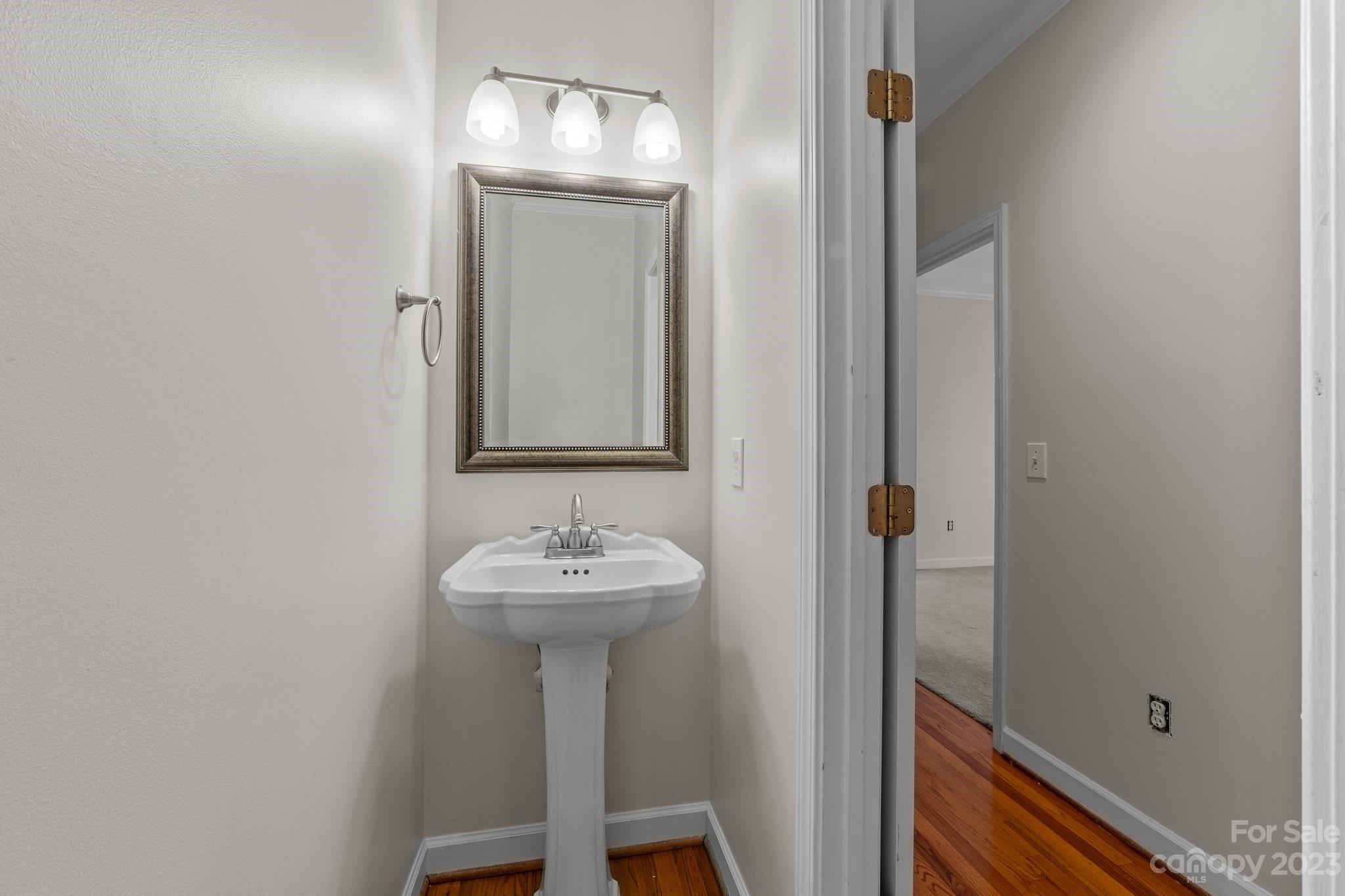 5476 Deer Run Court Davidson, NC 28036 - Photo 30 of 48 a bathroom with a sink a mirror and shower