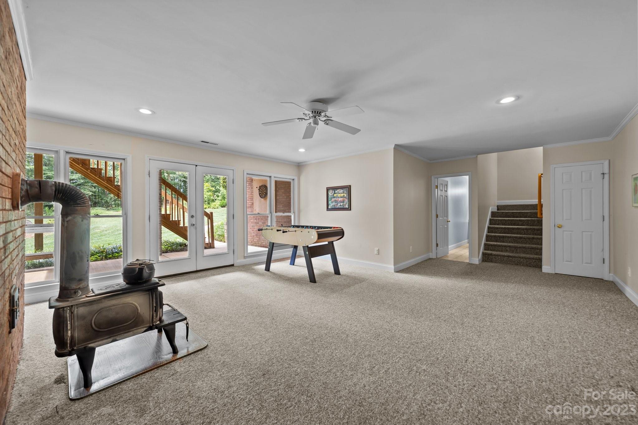 5476 Deer Run Court Davidson, NC 28036 - Photo 45 of 48 a living room with furniture and a gym machine with wooden floor