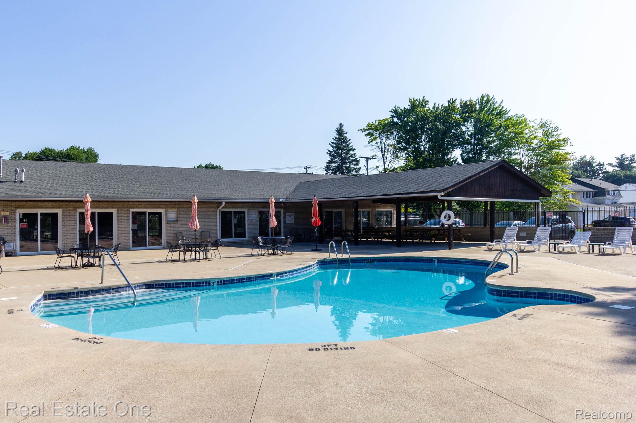 111 Manor Way Rochester, MI 48309 - Photo 36 of 36 Freeform swimming pool with integrated steps and perimeter tiling