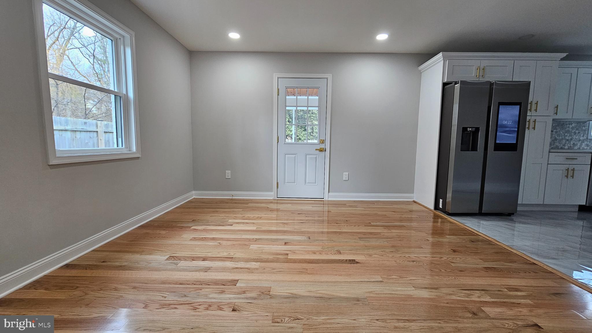 1305 Woodside Parkway Silver Spring, MD 20910 - Photo 12 of 41 an empty room with wooden floor and windows