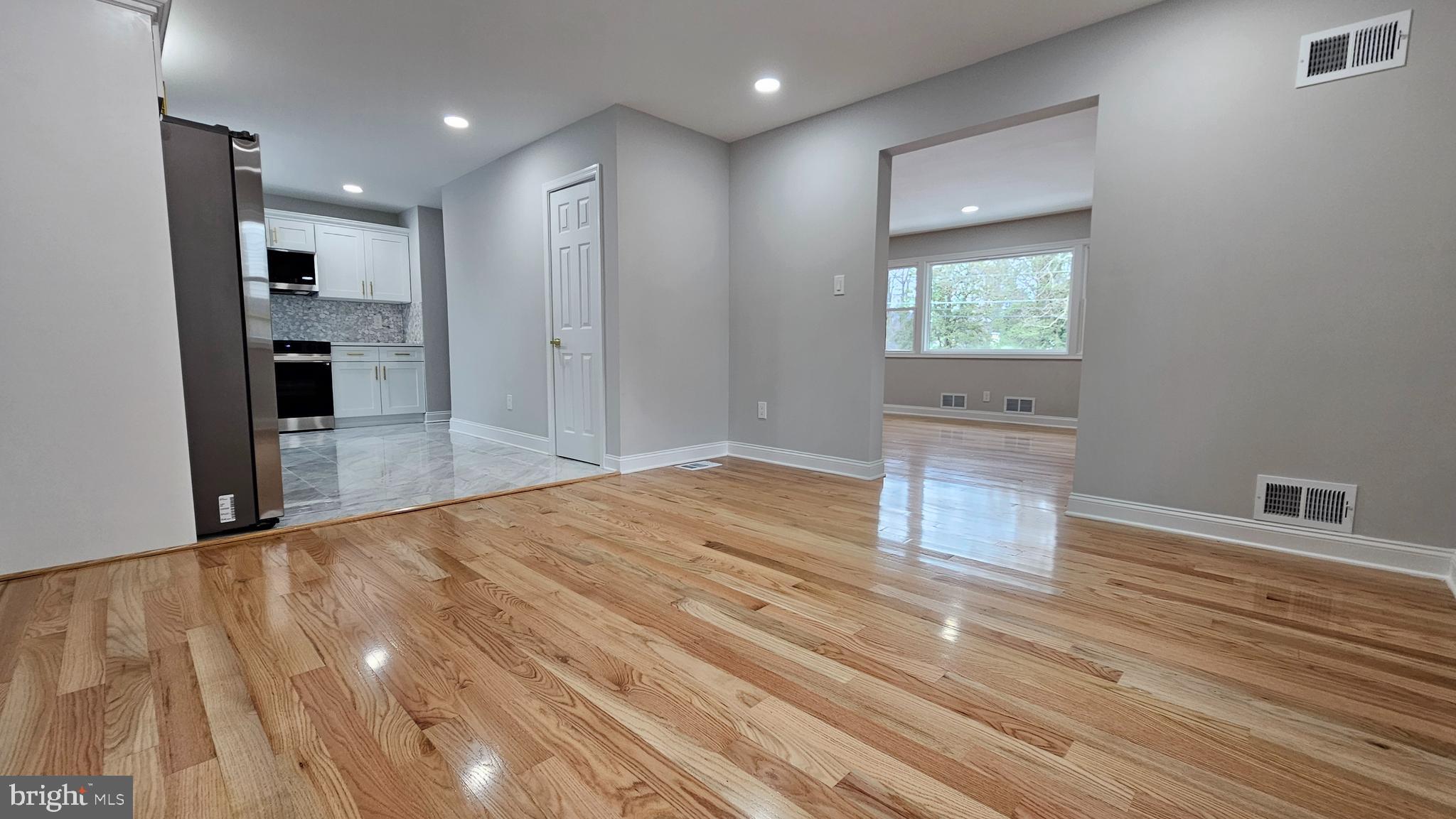 1305 Woodside Parkway Silver Spring, MD 20910 - Photo 13 of 41 a view of empty room with wooden floor and window