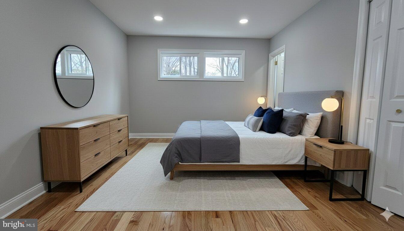 1305 Woodside Parkway Silver Spring, MD 20910 - Photo 15 of 41 a spacious bedroom with a bed and a mirror on dresser