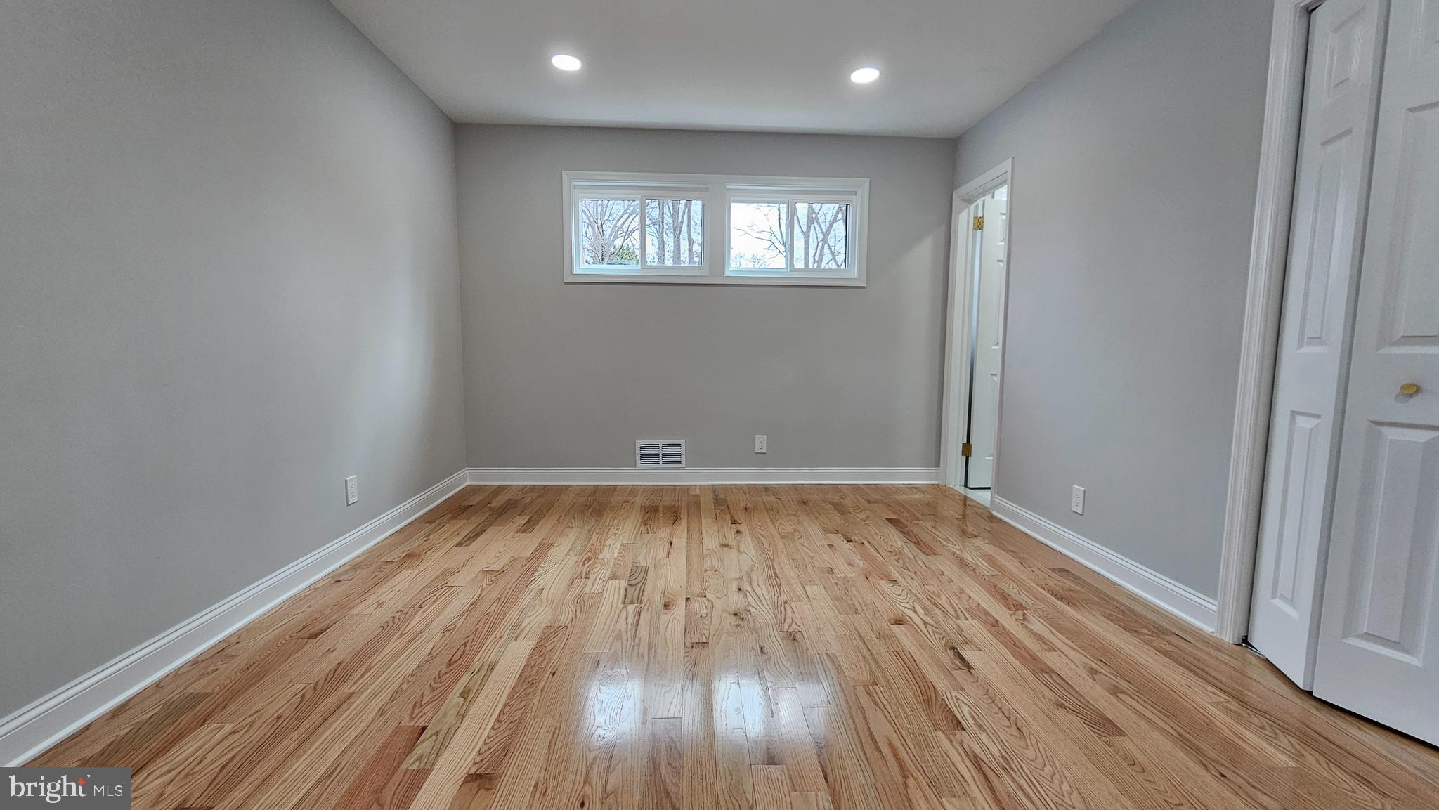 1305 Woodside Parkway Silver Spring, MD 20910 - Photo 16 of 41 an empty room with wooden floor and windows