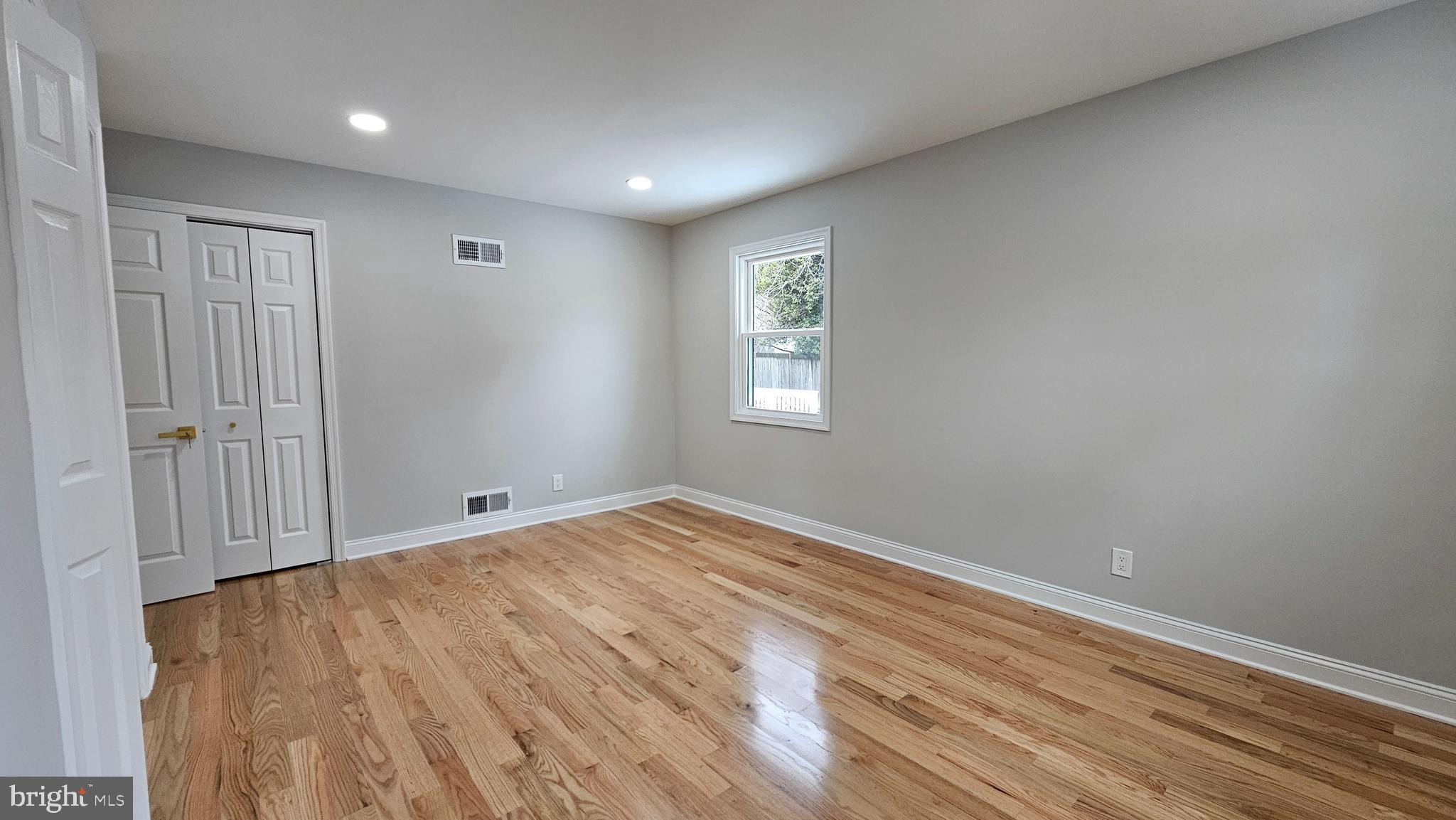 1305 Woodside Parkway Silver Spring, MD 20910 - Photo 17 of 41 a view of an empty room with wooden floor and a window