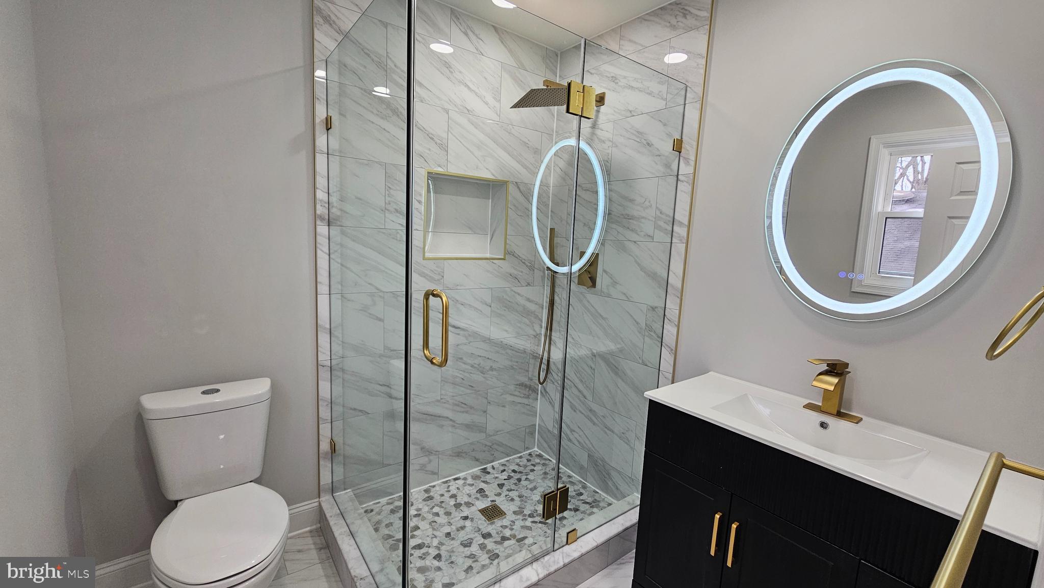 1305 Woodside Parkway Silver Spring, MD 20910 - Photo 18 of 41 a bathroom with a toilet a sink and mirror