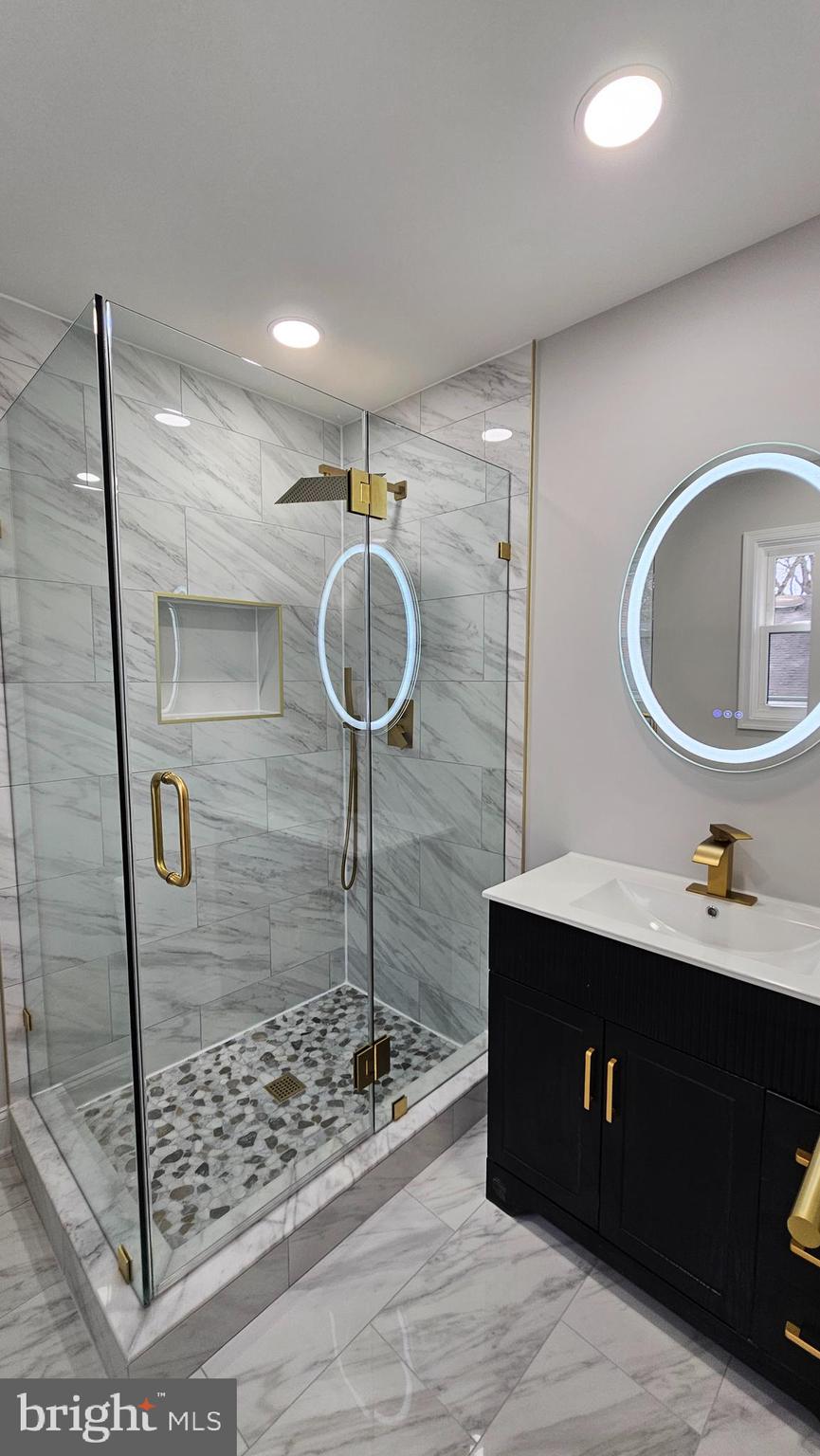 1305 Woodside Parkway Silver Spring, MD 20910 - Photo 19 of 41 a kitchen with kitchen island a sink a counter and a refrigerator