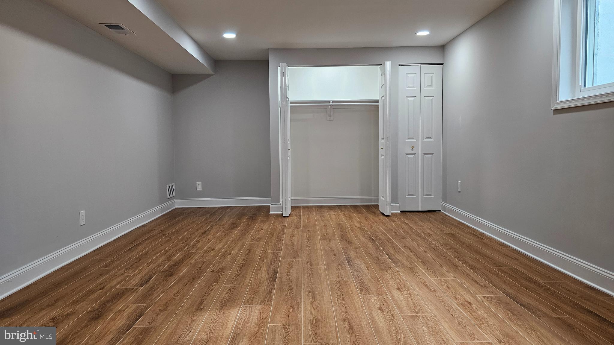 1305 Woodside Parkway Silver Spring, MD 20910 - Photo 29 of 41 a view of an empty room with wooden floor and a window