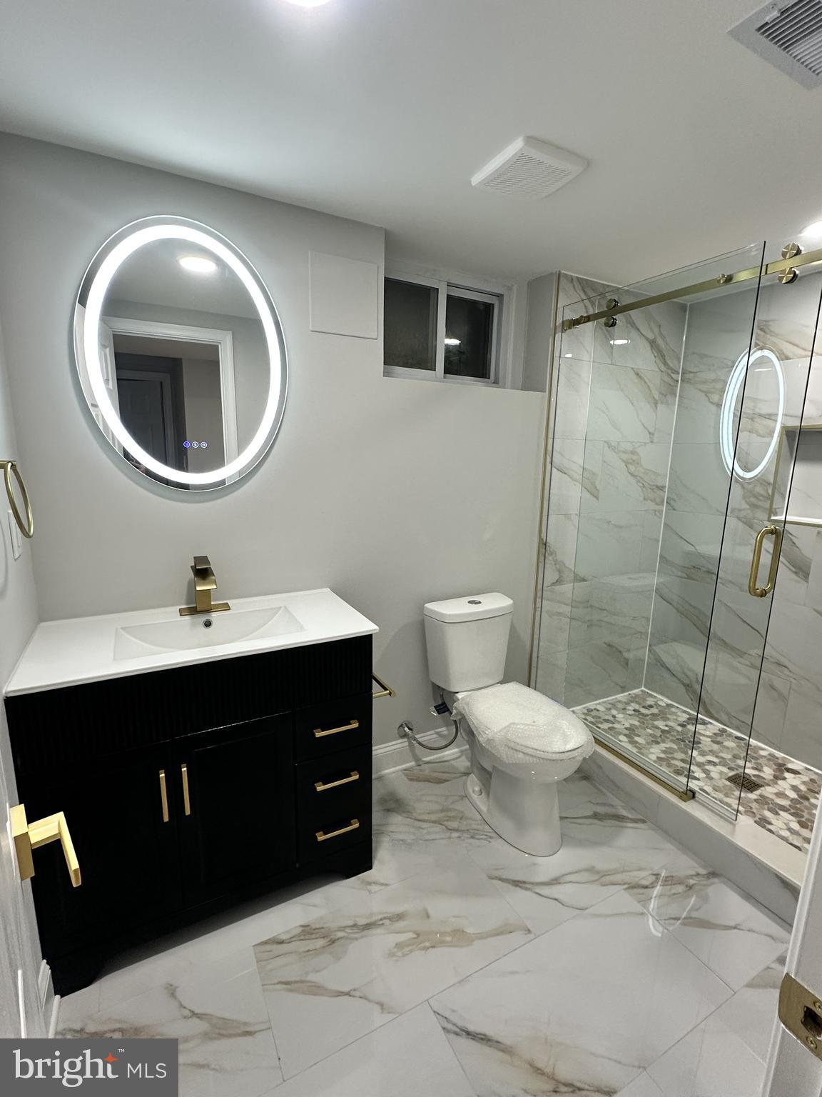 1305 Woodside Parkway Silver Spring, MD 20910 - Photo 34 of 41 a bathroom with a toilet sink and mirror