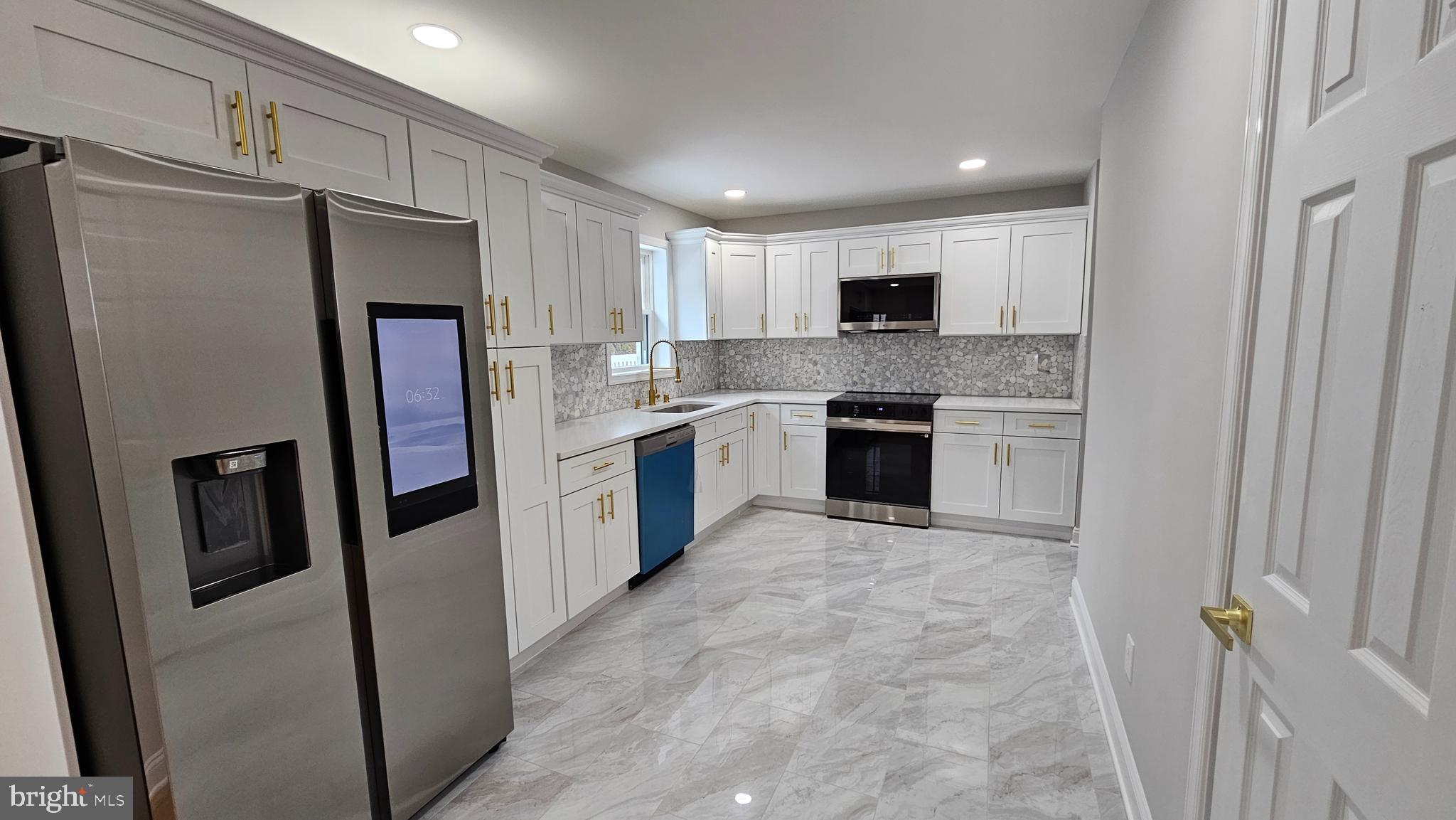 1305 Woodside Parkway Silver Spring, MD 20910 - Photo 6 of 41 a kitchen with stainless steel appliances granite countertop a refrigerator stove top oven and sink