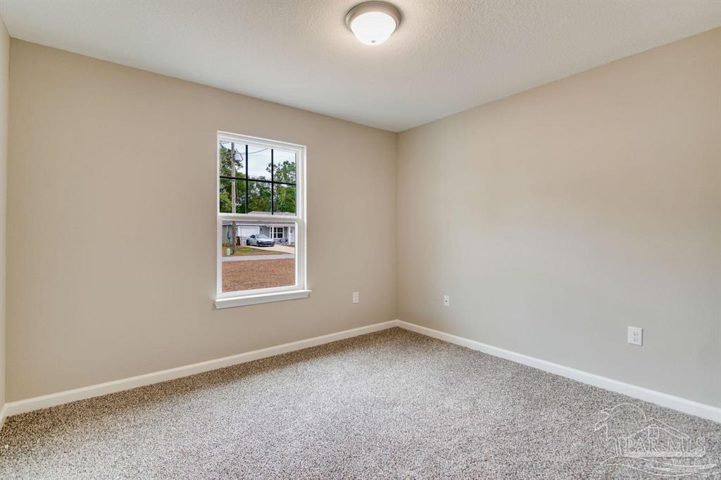 5601 Riviera Drive Milton, FL 32583 - Photo 14 of 18 an empty room with a window