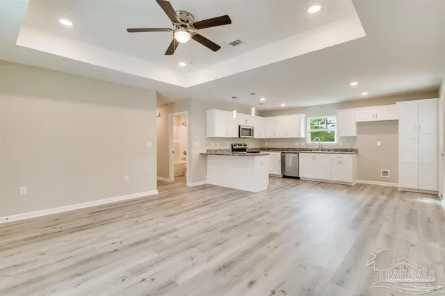 a view of a kitchen with a sink and a stove top oven