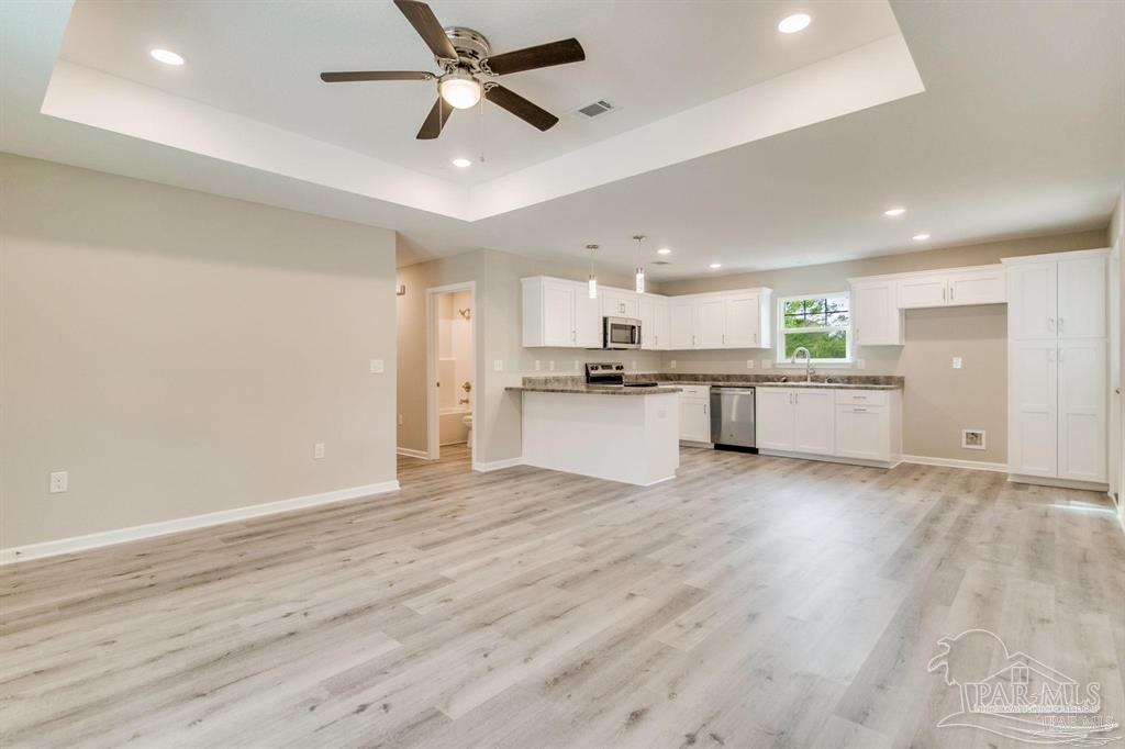 5601 Riviera Drive Milton, FL 32583 - Photo 2 of 18 a view of a kitchen with a sink and a stove top oven