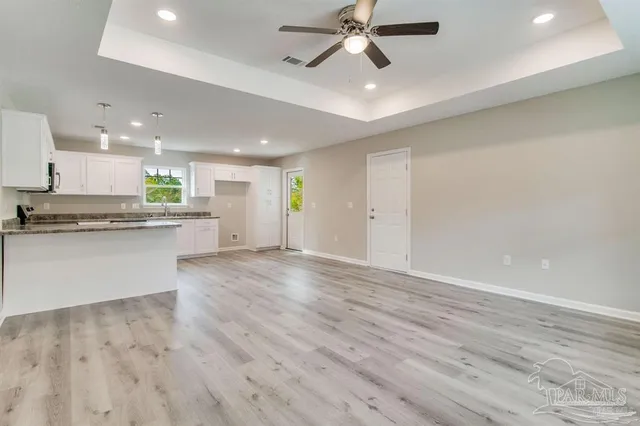 a view of a kitchen with a dishwasher and a stove top oven