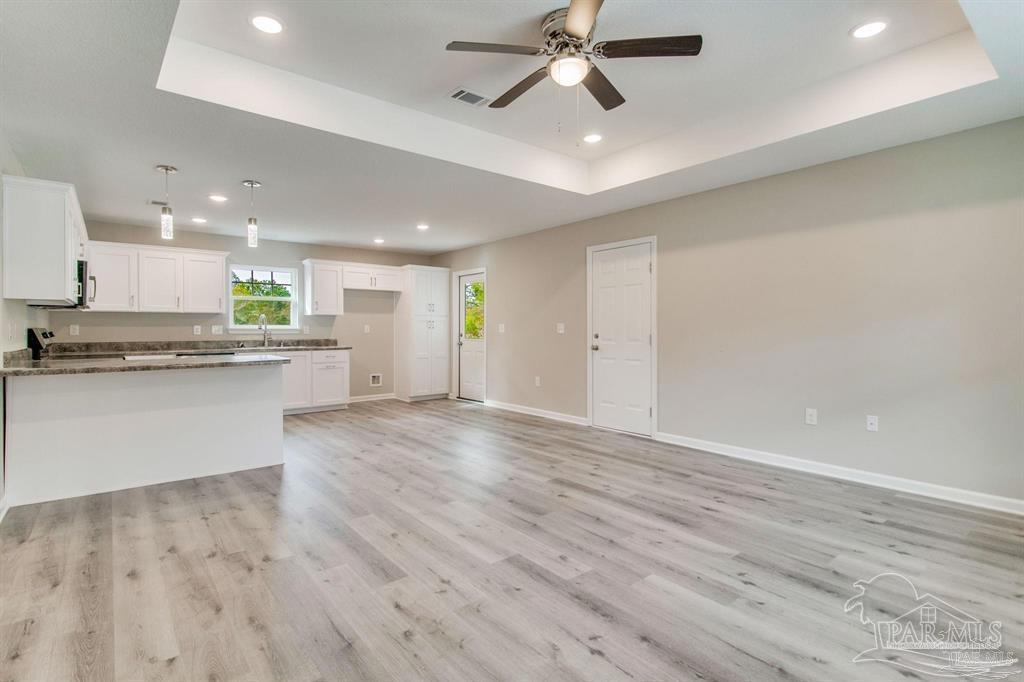 5601 Riviera Drive Milton, FL 32583 - Photo 3 of 18 a view of a kitchen with a dishwasher and a stove top oven