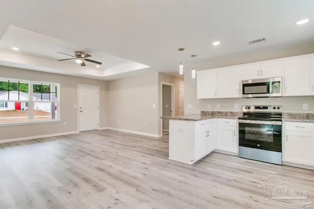 a kitchen with stainless steel appliances a stove a sink and a refrigerator