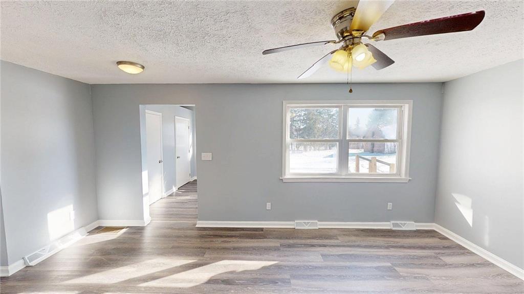 188 Reiber Road Renfrew, PA 16053 - Photo 4 of 38 an empty room with wooden floor fan and windows
