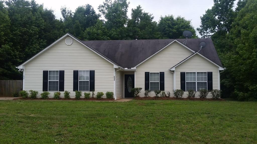4909 Whitehall Road Lula, GA 30554 - Photo 1 of 1 a view of a house with a yard and garden