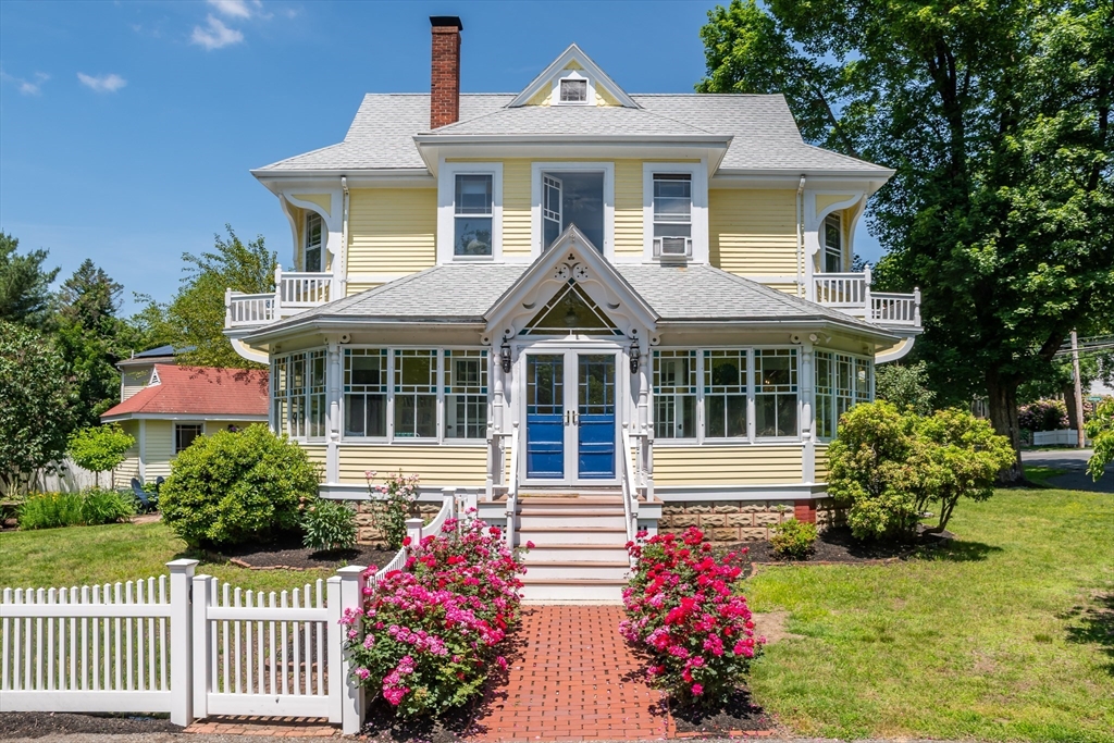 8 Charles Street Natick, MA 01760 - Photo 1 of 36 a front view of a house with a yard and fence