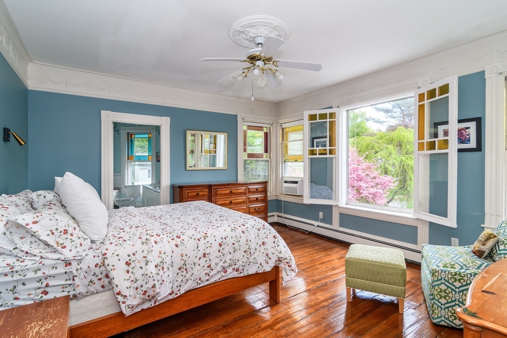 8 Charles Street Natick, MA 01760 - Photo 17 of 36 a bedroom with a large bed and a chandelier