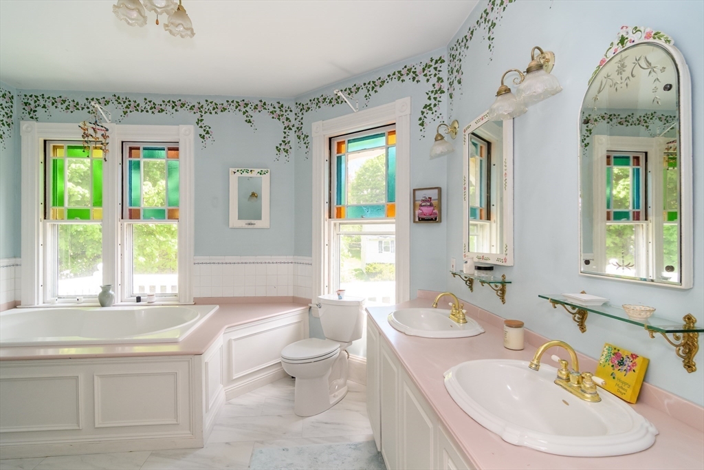 8 Charles Street Natick, MA 01760 - Photo 18 of 36 a bathroom with a granite countertop sink and a large mirror