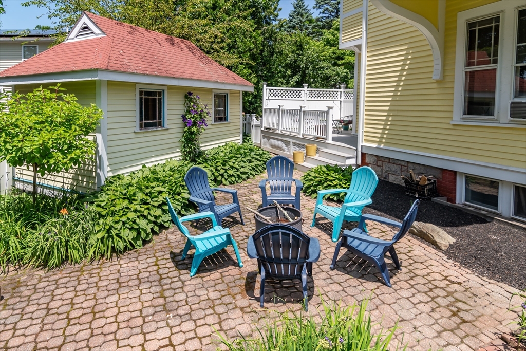 8 Charles Street Natick, MA 01760 - Photo 30 of 36 a view of a patio with table and chairs and potted plants