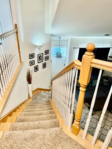 a view of a room with wooden floor and furniture