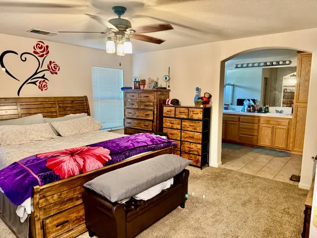 a bedroom with a bed and window