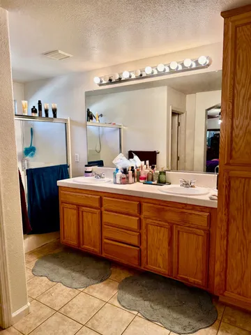 a bathroom with a sink mirror and vanity