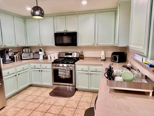 a living room with furniture and kitchen view