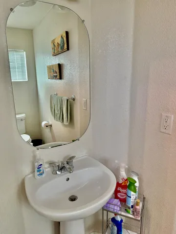 a white toilet sitting in a bathroom next to a window