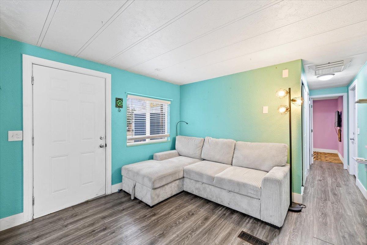 8880 Auburn Folsom Road, Unit 20 Granite Bay, CA 95746 - Photo 5 of 17 a living room with furniture and a wooden floor