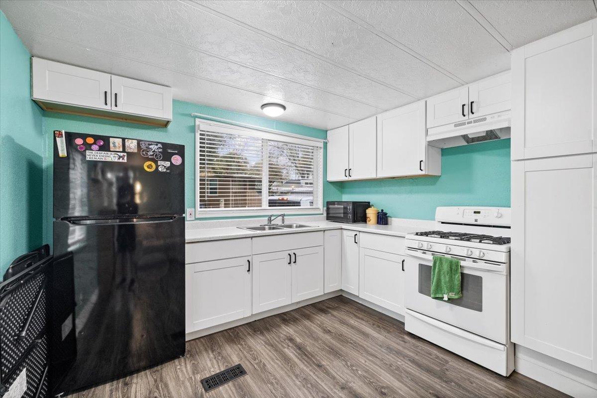 8880 Auburn Folsom Road, Unit 20 Granite Bay, CA 95746 - Photo 8 of 17 a kitchen with a refrigerator and white cabinets
