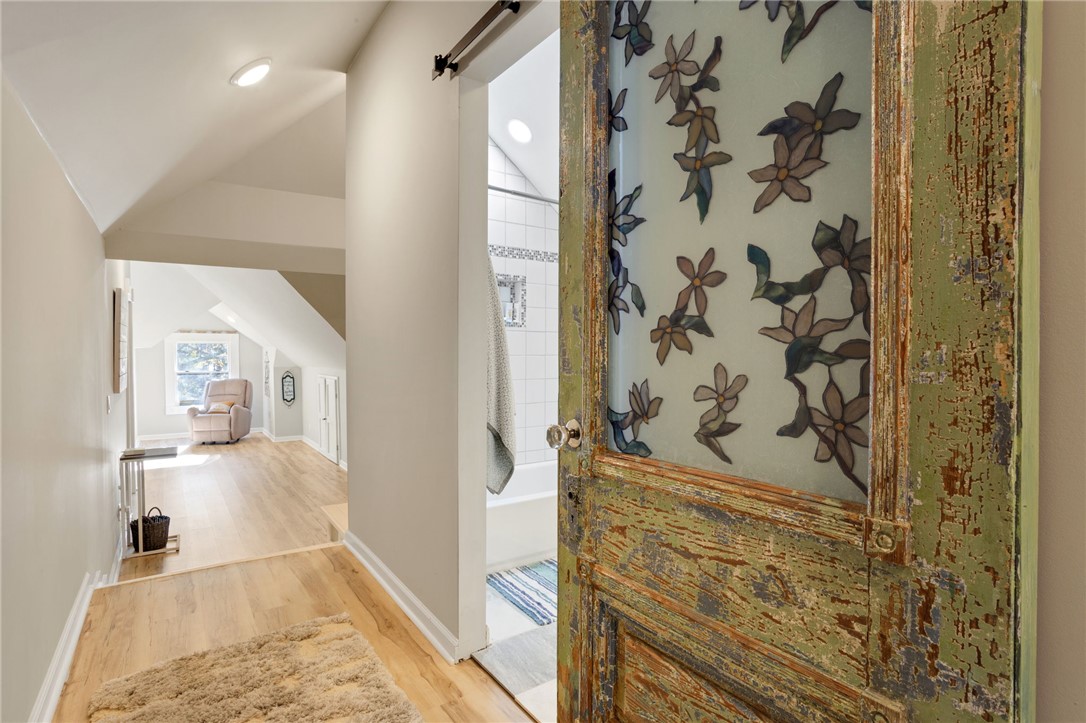 1133 Elrod Ferry Road Hartwell, GA 30643 - Photo 29 of 46 This interior hallway features a distinctive sliding door leading to a modern bathroom.