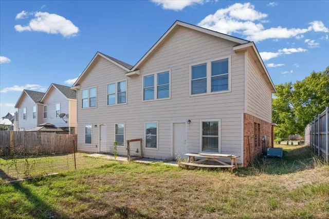 a backyard of a house with yard and outdoor seating